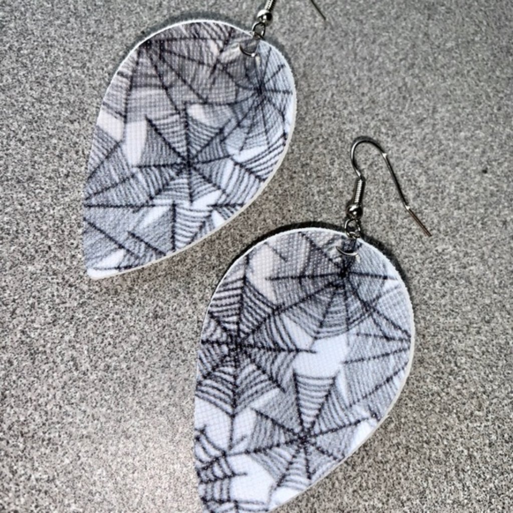 Coppe: White Faux Leather Spider's Web Earrings